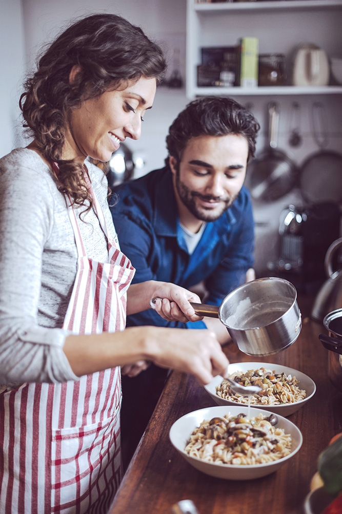 Young couple cooking. Man and woman in their kitchen