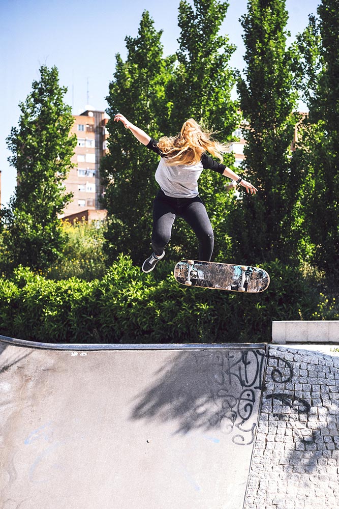 Skateboarding woman practicing at skatepark