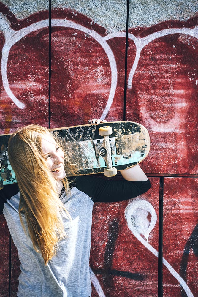 Cool skateboard woman at a public graffiti park