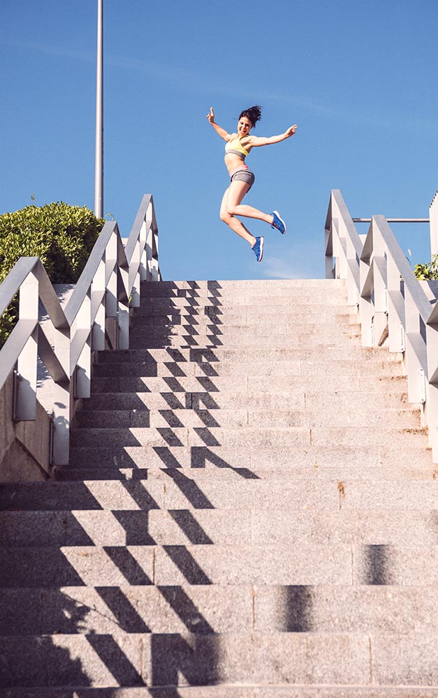 Athletic woman running up stairs during cardio - interval traini