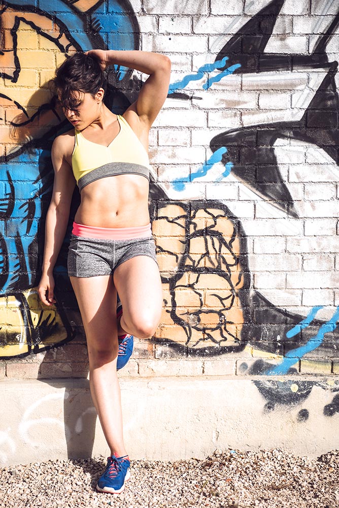 Sporty woman Posing near Urban Wall Grafitti