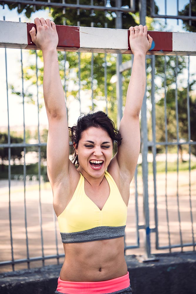 Young Woman working out outdoors and having fun