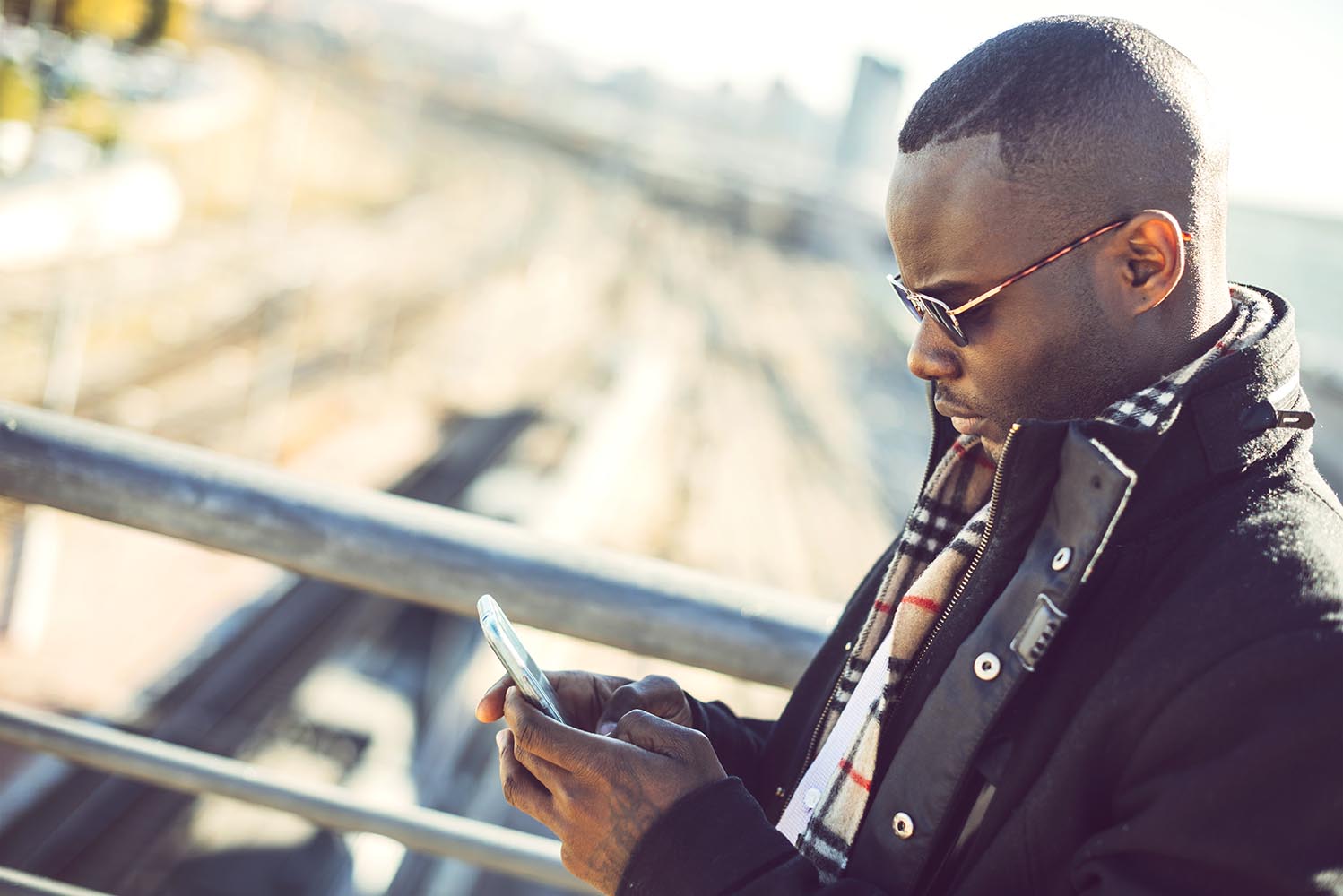 Black elegant man using smartphone