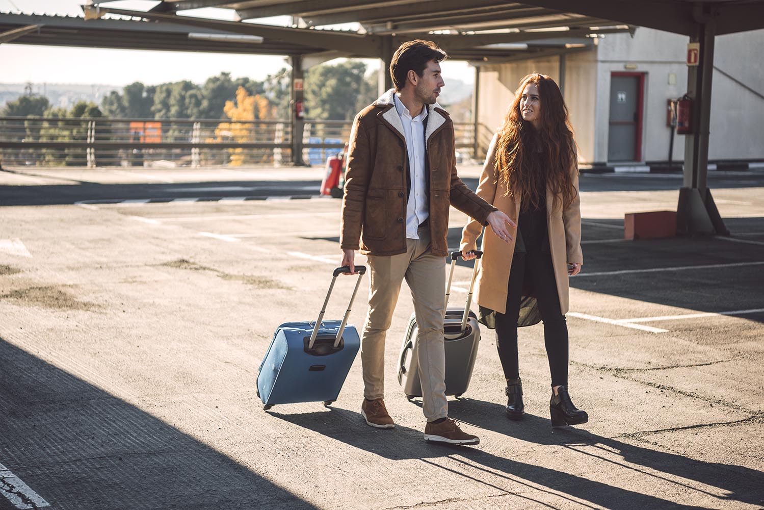 Couple walking and talking with luggage