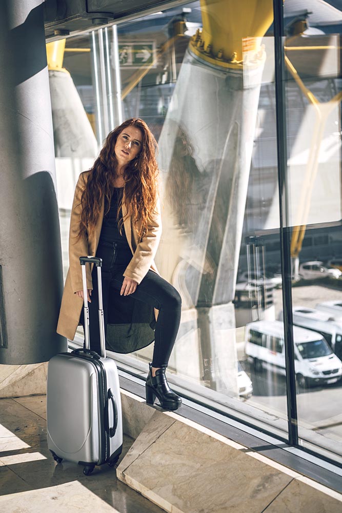 Stylish woman with suitcase