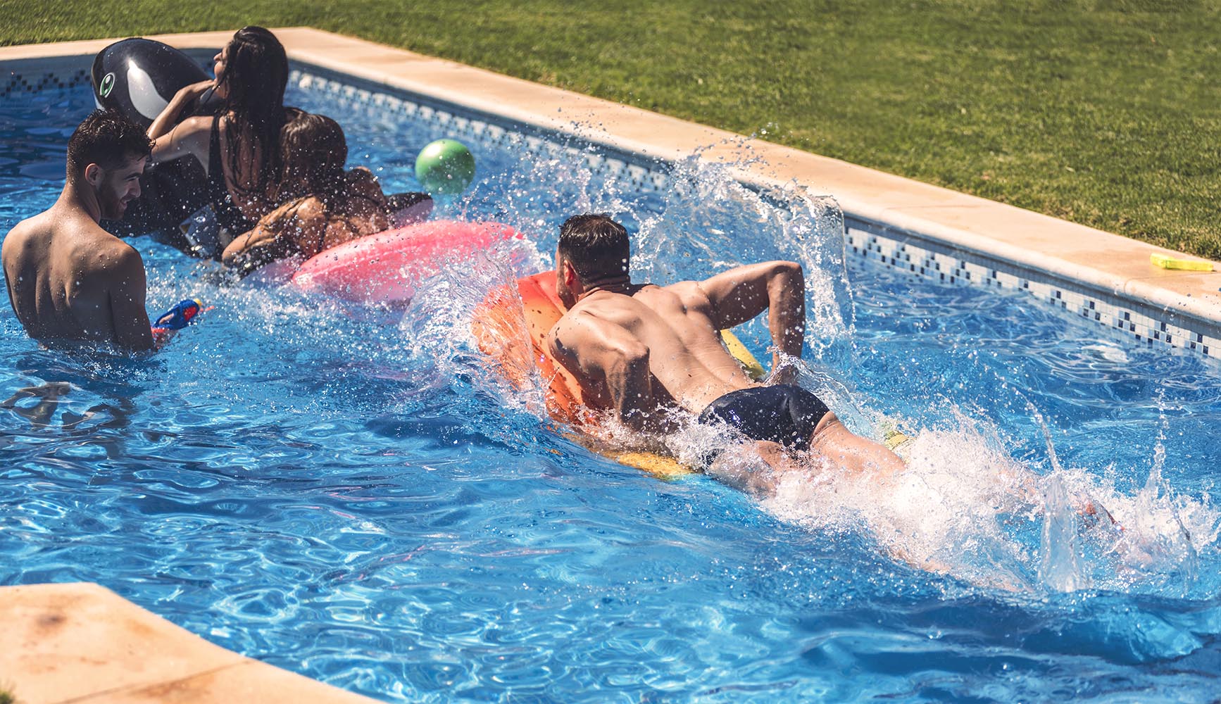 Men and women having fun in pool