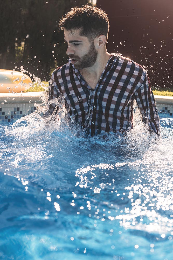 Dressed man in swimming pool