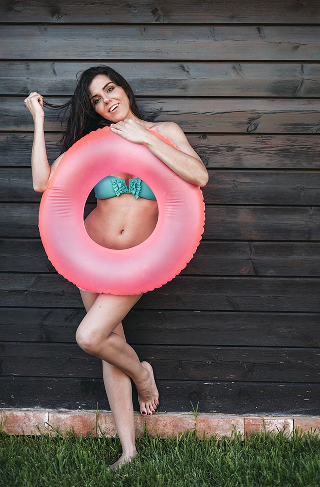 Girl in bikini holding swimming ring