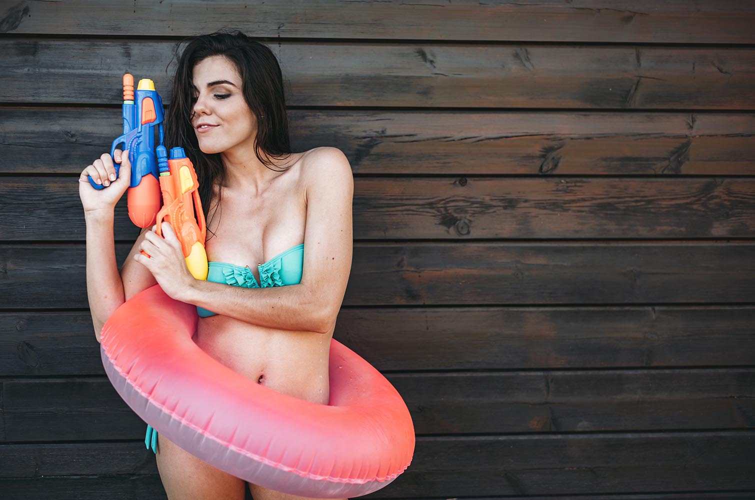 Young lady with two water guns posing