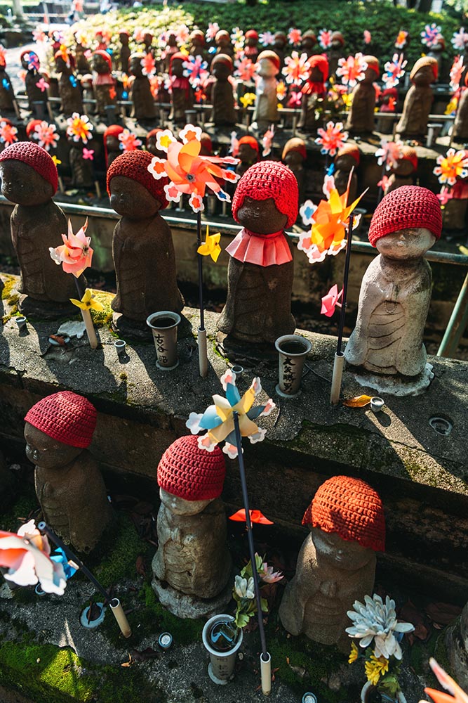 Jizo statues with decoration and flowers at Zojoji temple, in To
