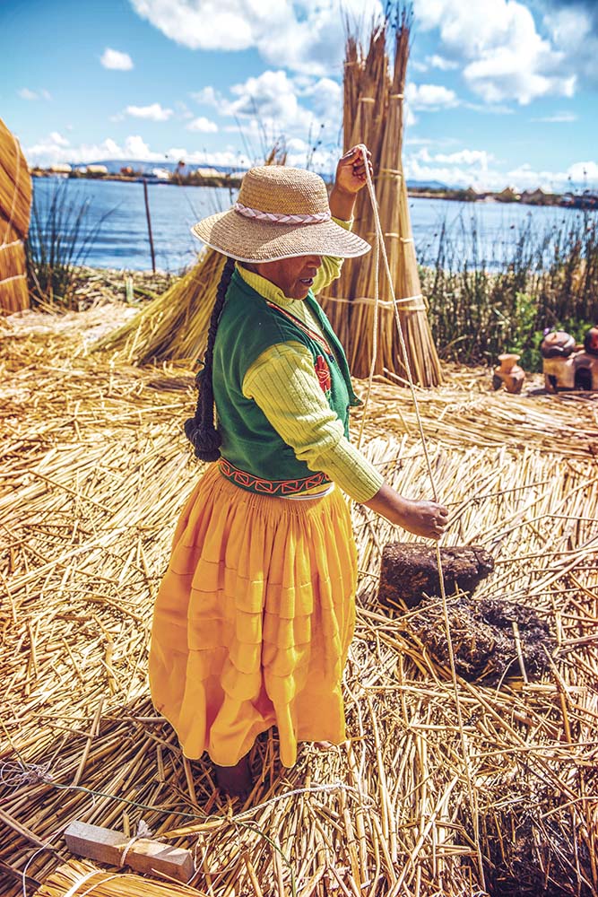 TITICACA, PERU - DEC 29: Indian woman peddling her wares on a re