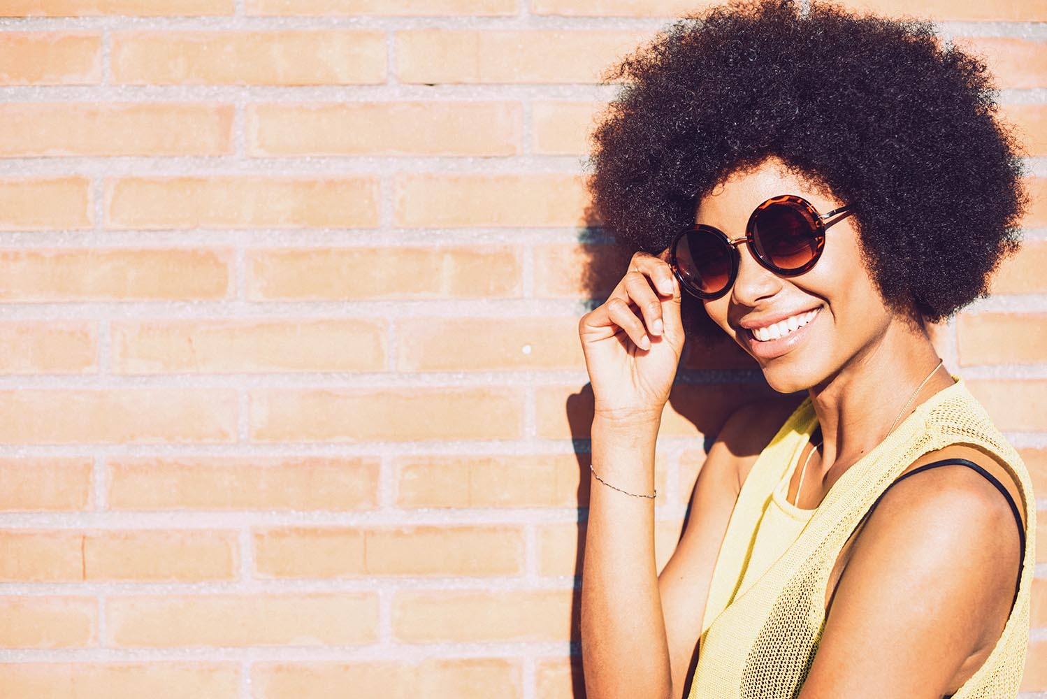 Young beautiful Afro-American woman posing and smiling while sta