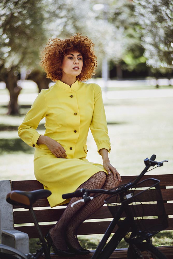 Redhaired beauty woman fashion girl on bicycle with chinesse umb