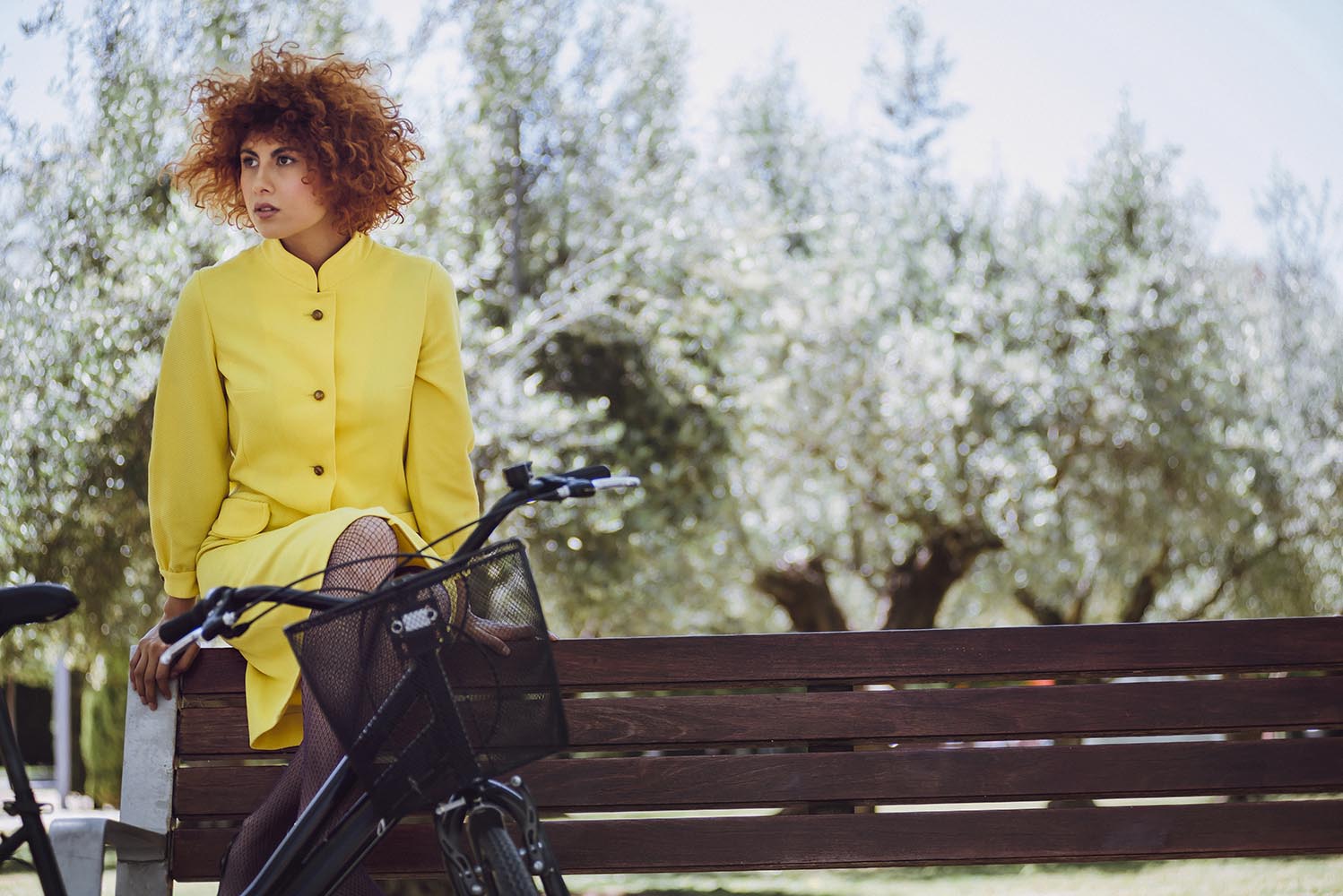 Redhaired beauty woman fashion girl on bicycle with chinesse umb