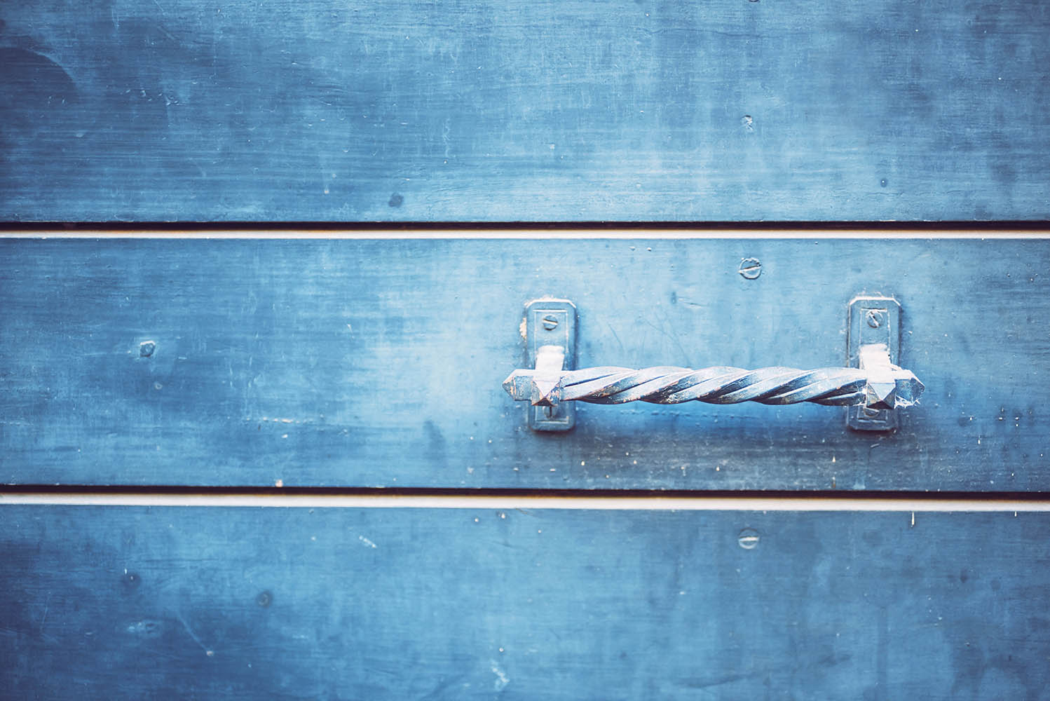 Detail of doors made of wood painted blue. Texture background
