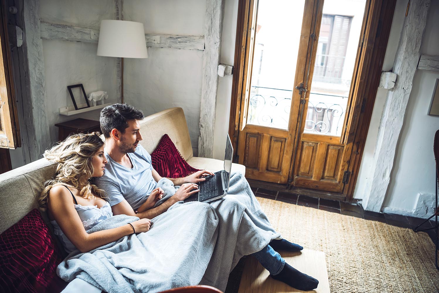 Sweet couple on couch with laptop