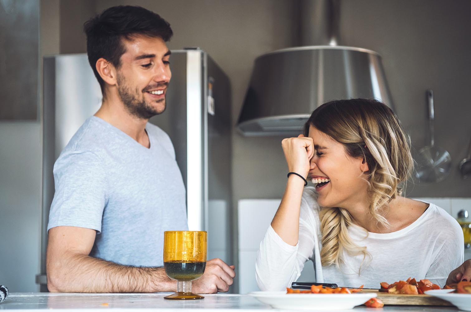 Cheerful young couple at kitchen