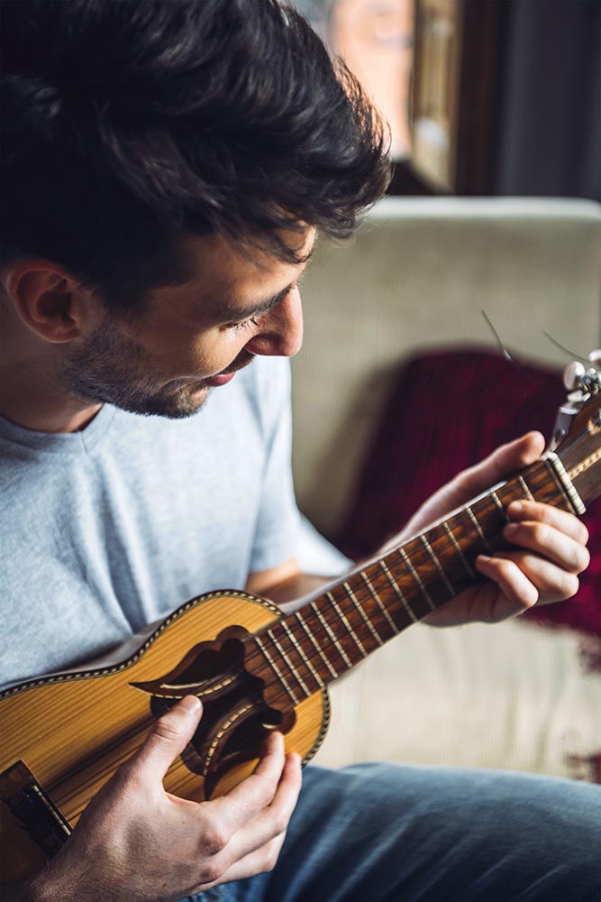 Man playing small guitar