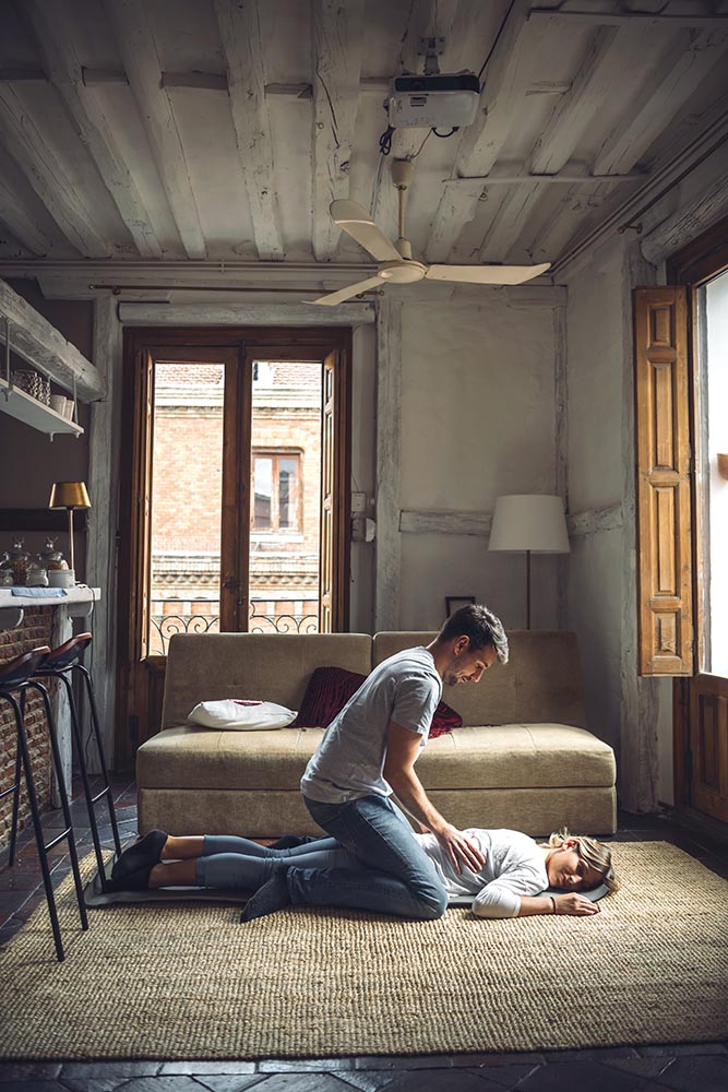 Loving couple massaging in living room