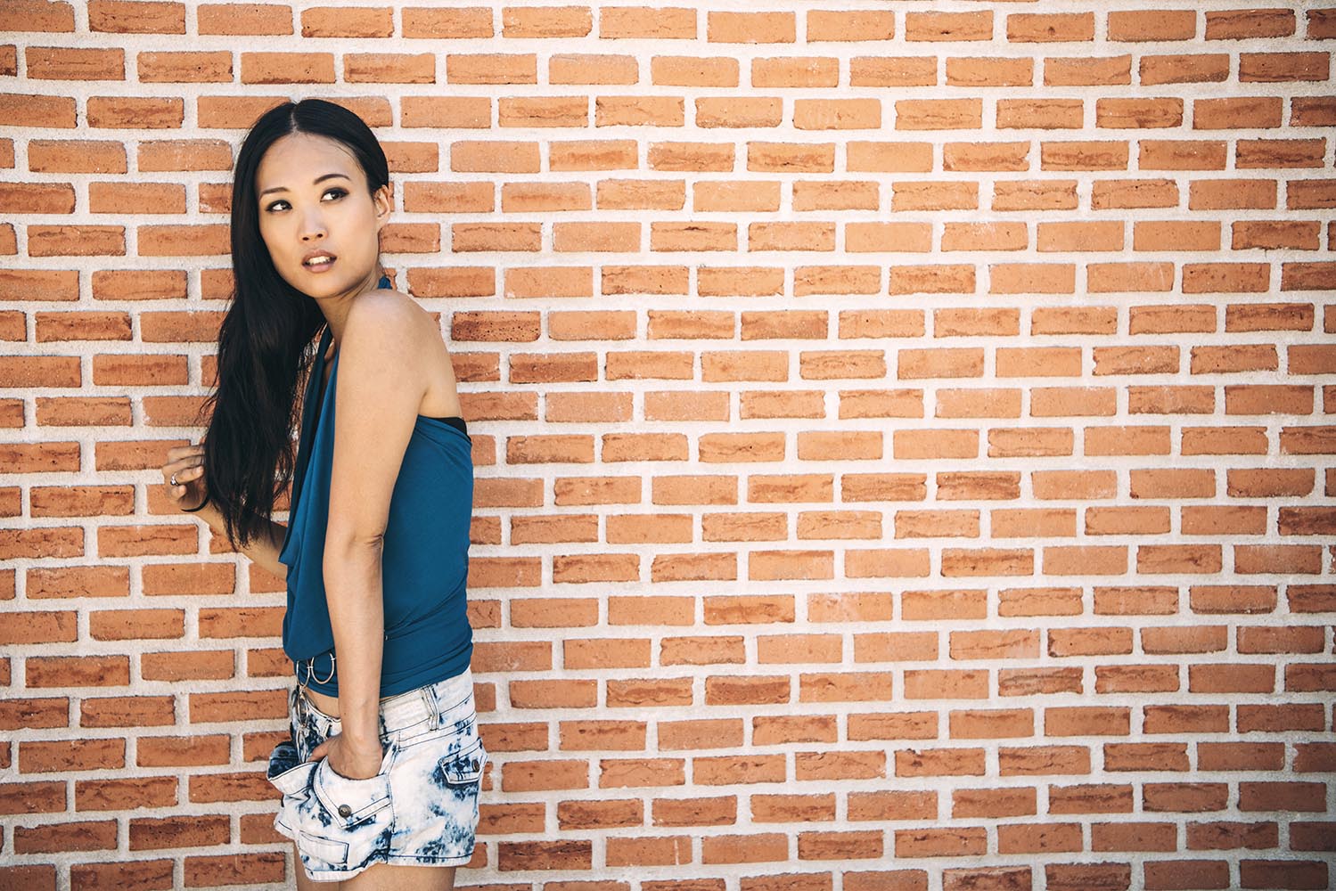 Sensual woman posing on brick wall
