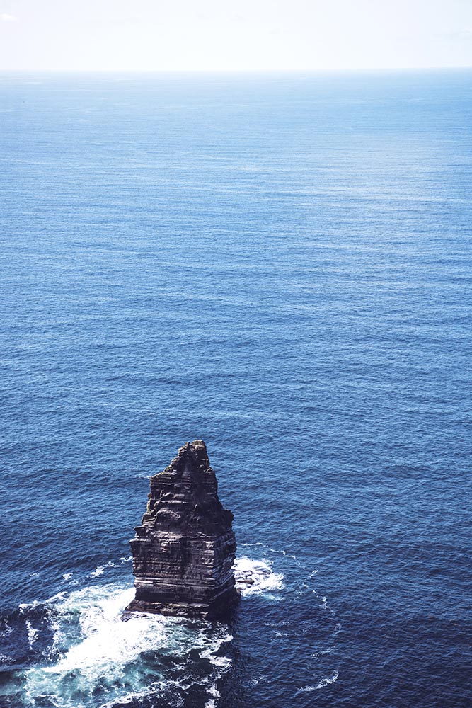 View of rock in ocean from Cliffs of Moher, Ireland.