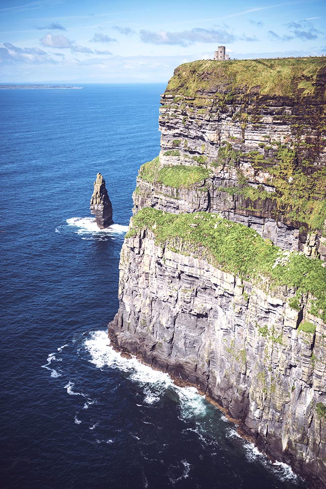 Massive cliffs of Moher on Atlantic ocean on sunny day, Ireland