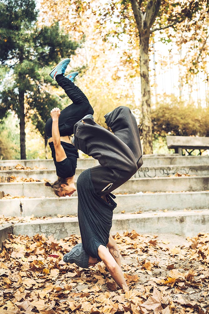 Young men performing parkour tricks in park