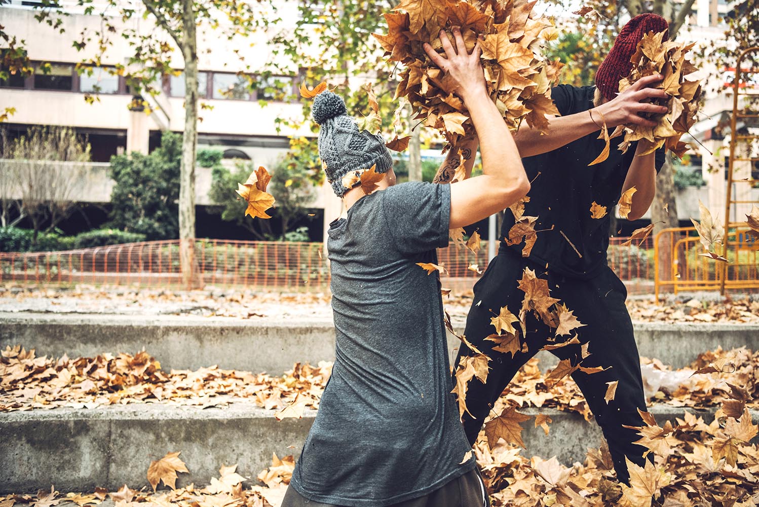 Freerunners playing with leaves in park