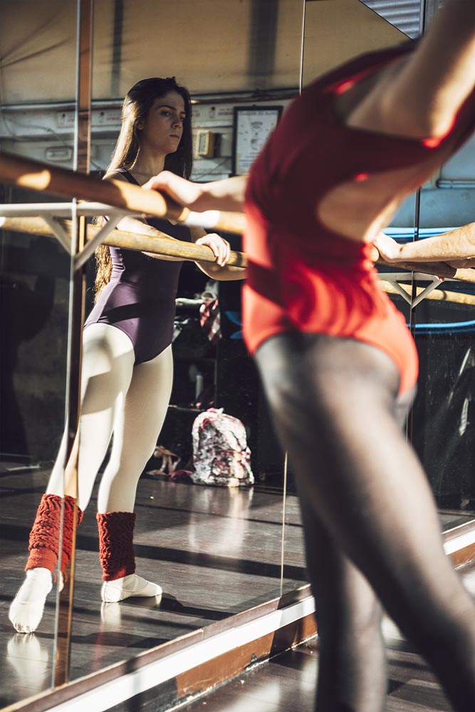 Professional dancer warming with barre