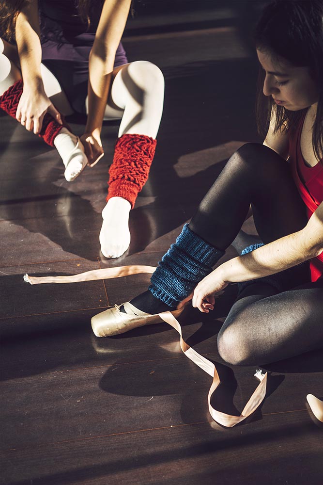 Women putting on pointe shoes