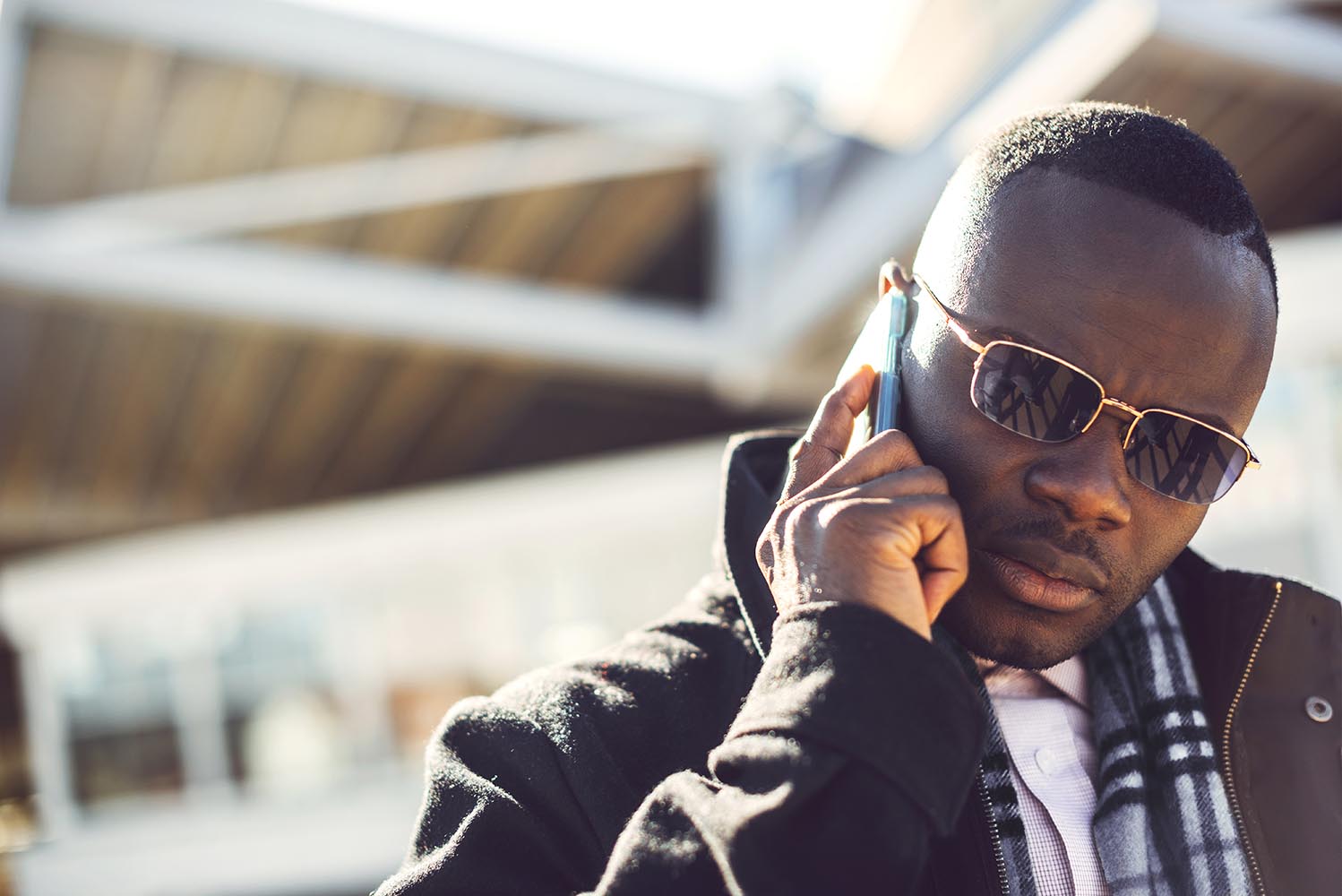 Serious black businessman speaking on phone