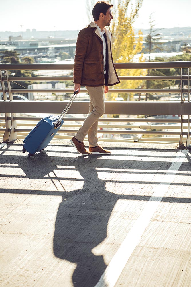 Elegant man with suitcase in airport