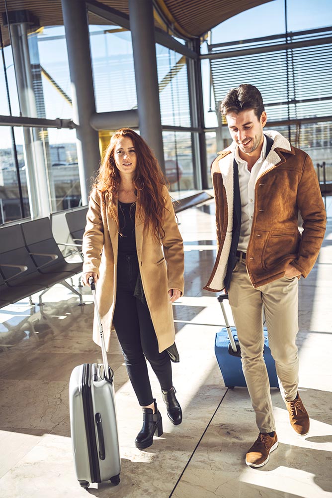 Cheerful happy couple walking in terminal
