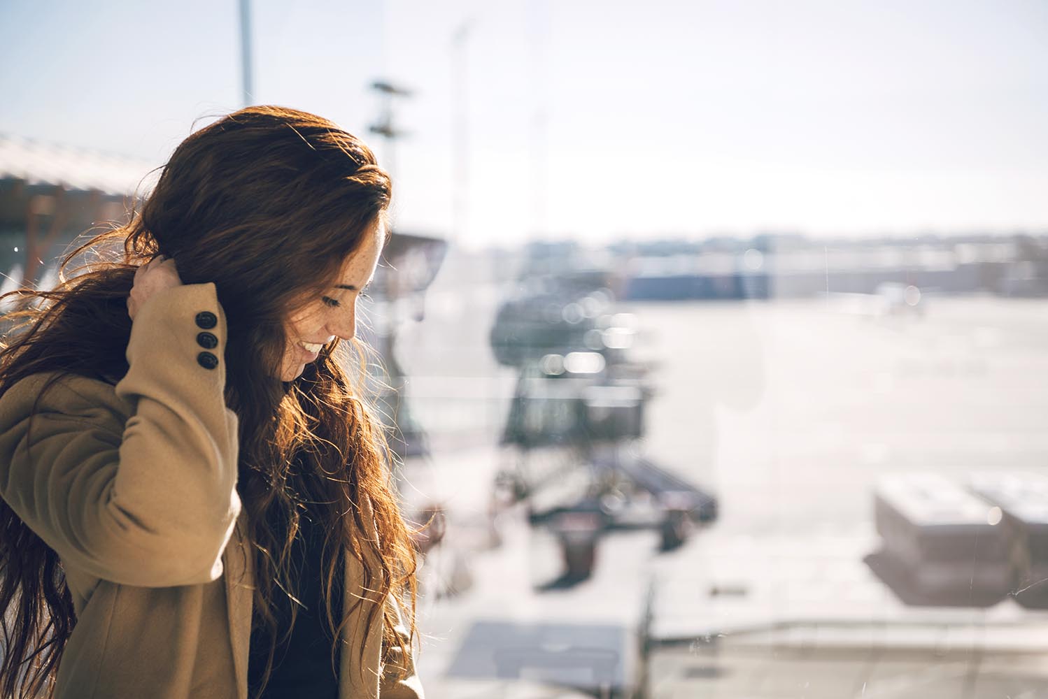 Cheerful redhead woman in airport