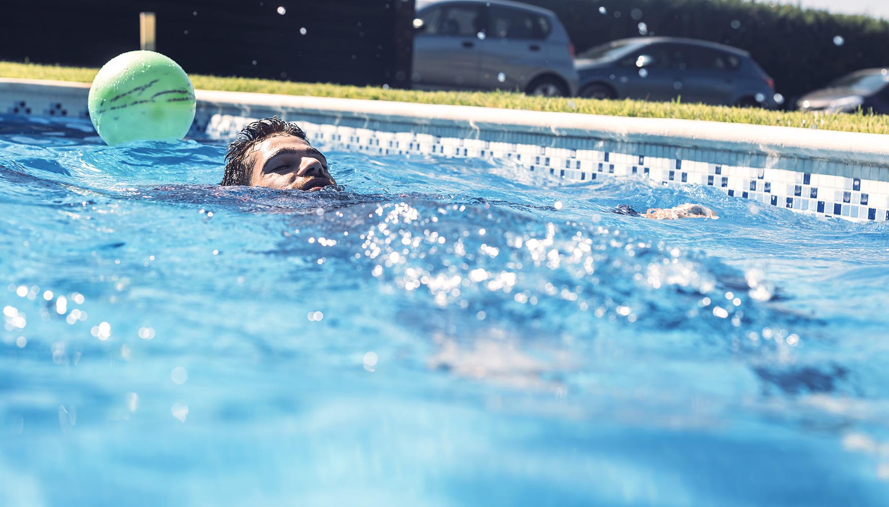 Man floating in swimming pool
