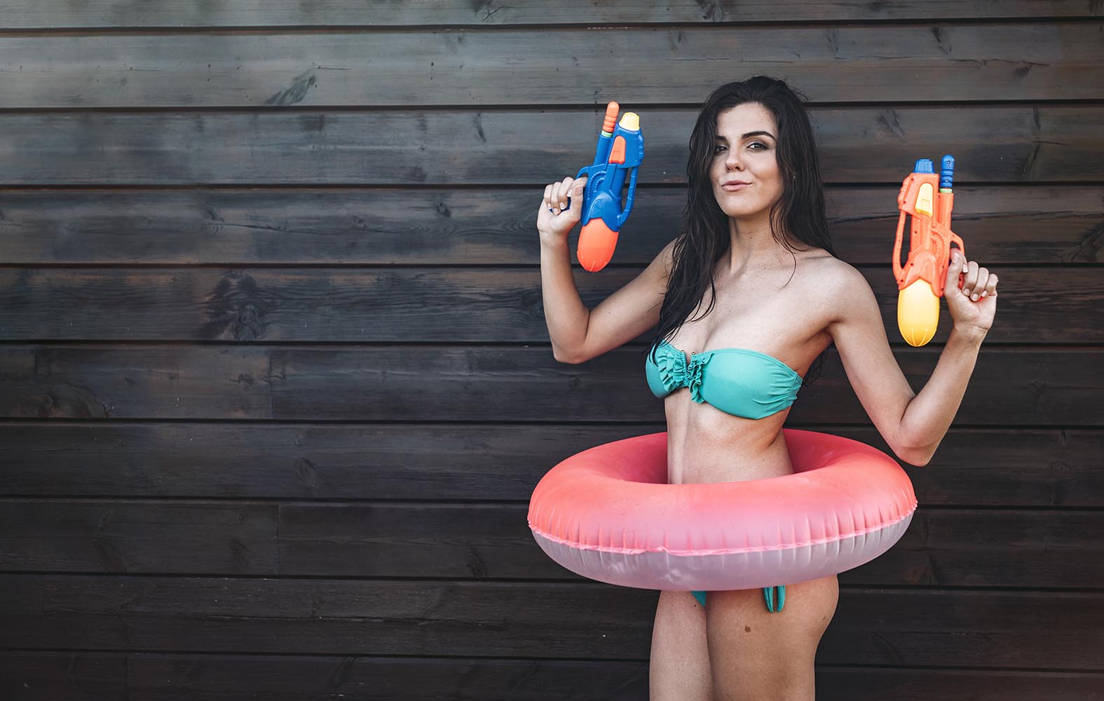 Young lady with two water guns posing