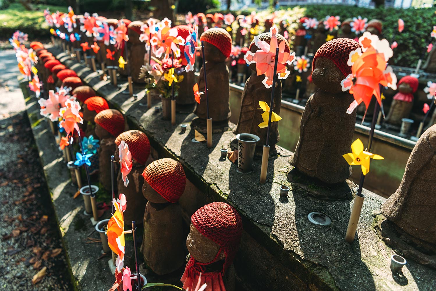 Jizo statues with decoration and flowers at Zojoji temple, in To
